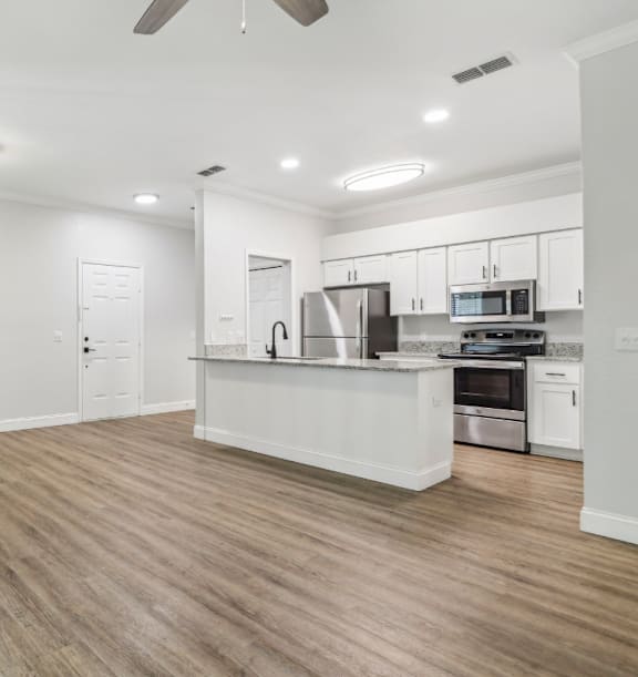 A spacious kitchen with a countertop and stainless steel appliances.